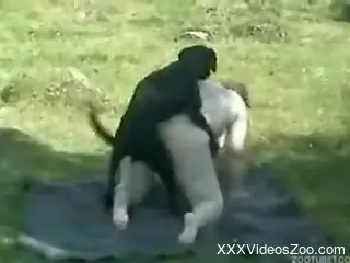 Fat MILF in a funny mask fucks a kinky dog outdoors
