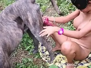 Masked chick enjoying outdoor action with a hung mutt