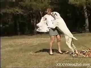 Aroused female tries sex with the dog in outdoor XXX